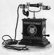 An 1896 antique telephone with stand and winding handle